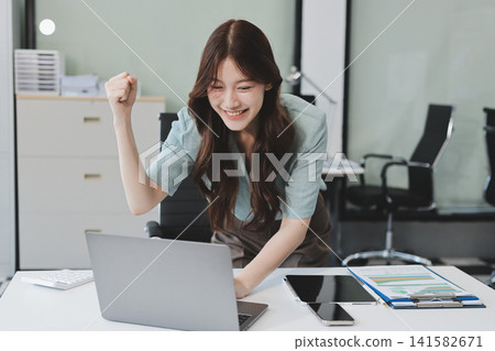 Businesswoman working with tablet and financial reports in modern office Businesswoman working with tablet and financial reports in modern office 141582671