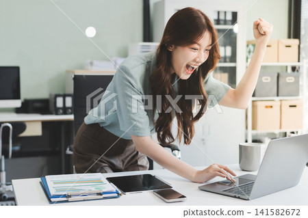 Businesswoman working with tablet and financial reports in modern office Businesswoman working with tablet and financial reports in modern office 141582672