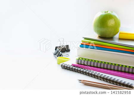 Colorful school supplies, book, apple on white. Close up. Back to school. Colorful school supplies, book, apple on white. Close up. Back to school. 141582958