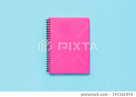 Pink girlish school supplies, notebooks on blue. Top view, flat lay. Copy space. Pink girlish school supplies, notebooks on blue. Top view, flat lay. Copy space. 141582959