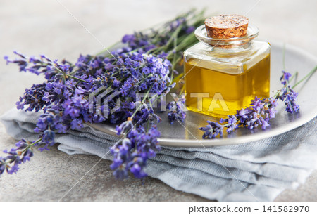 Lavender essential oil bottle with fresh purple flowers Lavender essential oil bottle with fresh purple flowers 141582970