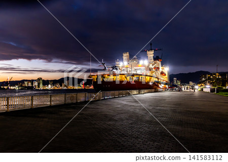 The Antarctic research vessel Shirase is anchored in Kobe Port at dusk. The Antarctic research vessel Shirase is anchored in Kobe Port at dusk. 141583112
