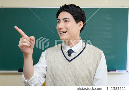 A Japanese male teacher pointing in the classroom A Japanese male teacher pointing in the classroom 141583311