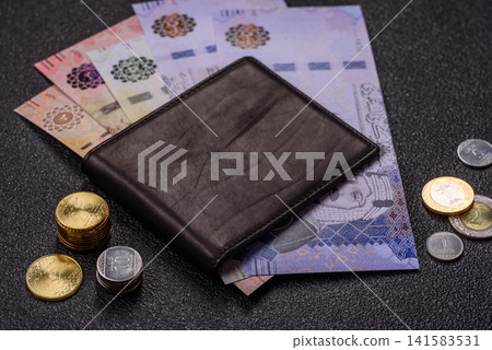 Saudi Arabia paper money, riyal banknotes and coins as currency for exchange. Saudi Arabia money Saudi Arabia paper money, riyal banknotes and coins as currency for exchange. Saudi Arabia money 141583531