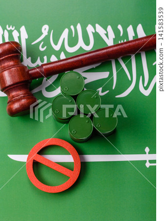 Metal barrels of oil, gas, or chemicals bearing on the flag of Saudi Arabia and a ban sign, embargo Metal barrels of oil, gas, or chemicals bearing on the flag of Saudi Arabia and a ban sign, embargo 141583539