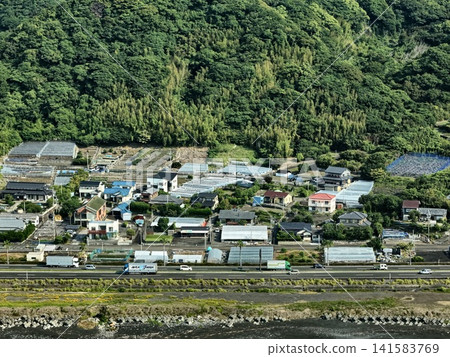 Aerial photograph capturing a mountainous coastal settlement and greenhouses in Shizuoka City. Aerial photograph capturing a mountainous coastal settlement and greenhouses in Shizuoka City. 141583769