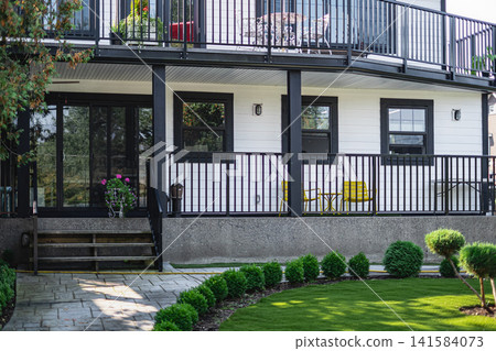 Landscaped backyard flower garden of residential house on a sunny day 141584073