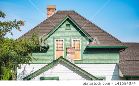 Top of the wooden house with nice windows and chimney in countryside of Canada Top of the wooden house with nice windows and chimney in countryside of Canada 141584074