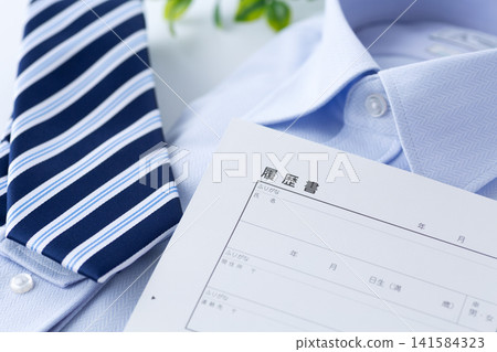 Resume, blue regimental tie, and dress shirt Resume, blue regimental tie, and dress shirt 141584323