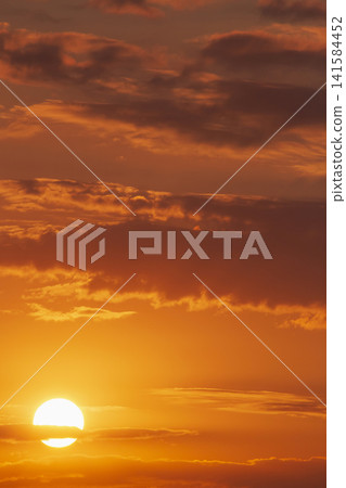 icturesque backdrop: view on sun rising behind clouds icturesque backdrop: view on sun rising behind clouds 141584452