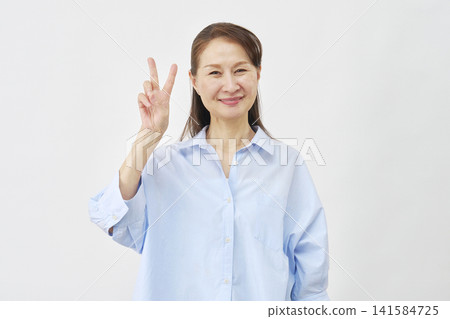 A woman making a peace sign on a white background A woman making a peace sign on a white background 141584725
