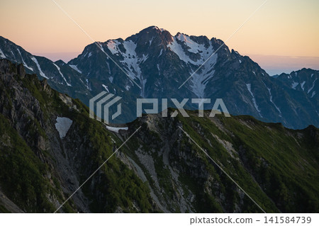 The sunrise over Mt. Tsurugi as seen from Mt. Renge in the Northern Alps. 141584739