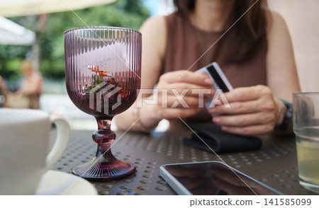 Girl Ready To Pay Meal, Holding Credit Card At Outdoor Restaurant 141585099