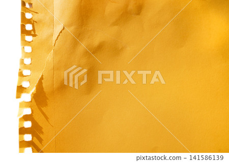 Yellow torn paper sheet with perforated edge and textured surface, suitable for backgrounds, notes, or creative design projects in various applications Yellow torn paper sheet with perforated edge and textured surface, suitable for backgrounds, notes, or creative design projects in various applications 141586139