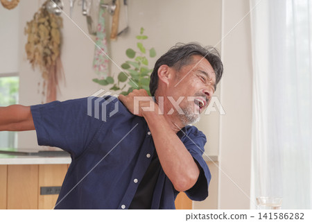 A man experiencing pain from his neck to his shoulder. A man experiencing pain from his neck to his shoulder. 141586282
