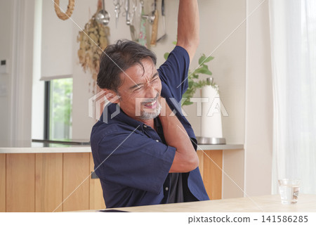 A man experiencing pain from his neck to his shoulder. A man experiencing pain from his neck to his shoulder. 141586285