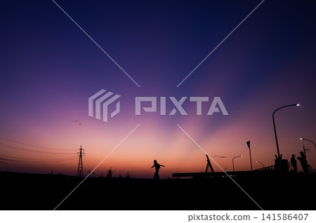 The silhouette of a woman running energetically through the gradient of the morning light. The silhouette of a woman running energetically through the gradient of the morning light. 141586407