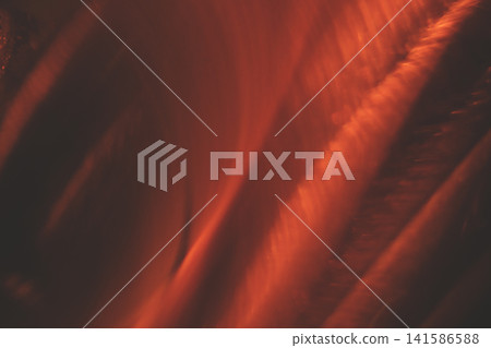 Abstract image featuring swirling patterns of warm orange and red hues, creating a dynamic visual effect reminiscent of flowing liquid or molten material Abstract image featuring swirling patterns of warm orange and red hues, creating a dynamic visual effect reminiscent of flowing liquid or molten material 141586588