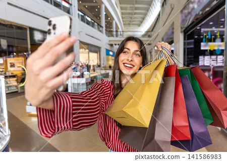 Pretty young caucasian woman making selfie and looking enjoyed Pretty young caucasian woman making selfie and looking enjoyed 141586983