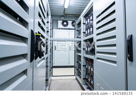 Industrial battery storage room with rows of cabinets and cooling system Industrial battery storage room with rows of cabinets and cooling system 141589135
