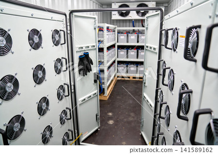 Industrial battery storage system with cooling fans and safety gloves Industrial battery storage system with cooling fans and safety gloves 141589162