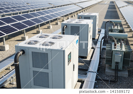 Rows of solar panels and electrical equipment on a sunny day Rows of solar panels and electrical equipment on a sunny day 141589172