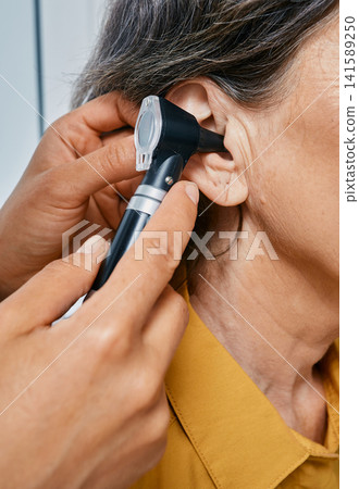 Hearing check-up, otoscopy. Diagnosis of impairment and hearing testing to senior people. Mature woman during ear test with audiologist Hearing check-up, otoscopy. Diagnosis of impairment and hearing testing to senior people. Mature woman during ear test with audiologist 141589250