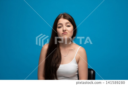 Young woman feeling disappointed or frustrated, making a frowning expression with pouting lips Young woman feeling disappointed or frustrated, making a frowning expression with pouting lips 141589280