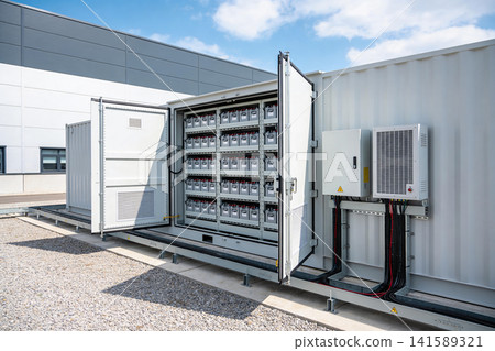 Large scale battery storage system container with open doors showing rows of batteries Large scale battery storage system container with open doors showing rows of batteries 141589321
