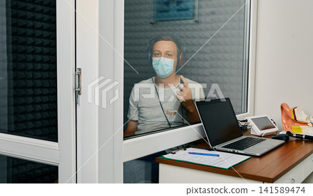 Adult man getting a hearing test at audiology center. Audiometry, hearing check up Adult man getting a hearing test at audiology center. Audiometry, hearing check up 141589474