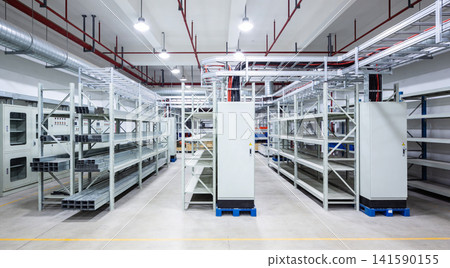 Modern industrial warehouse interior with extensive shelving and electrical conduits Modern industrial warehouse interior with extensive shelving and electrical conduits 141590155