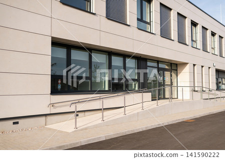 Modern architecture featuring accessible entrance and large windows Modern architecture featuring accessible entrance and large windows 141590222