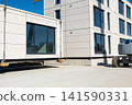 Modular building section being lifted into place by crane at construction site 141590331