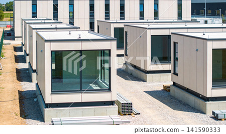 Modern modular buildings under construction on a sunny day Modern modular buildings under construction on a sunny day 141590333