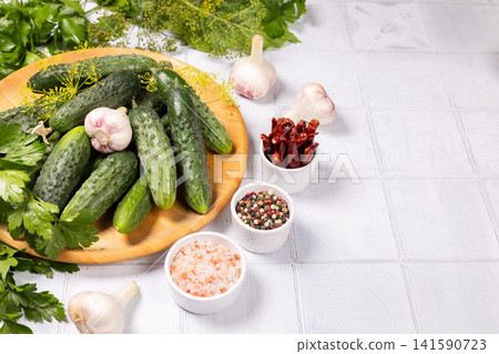 Fresh cucumbers, herbs, and spices preparing for pickling Fresh cucumbers, herbs, and spices preparing for pickling 141590723