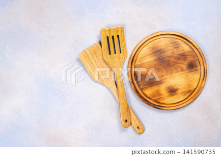 Wooden kitchen utensils and cutting board for cooking Wooden kitchen utensils and cutting board for cooking 141590735