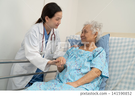 Asian doctor checking and treat elderly woman patient health in hospital. 141590852