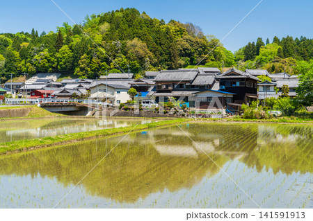 A spring landscape of traditional Japanese houses and rice paddies spread across the countryside of Kyoto. A spring landscape of traditional Japanese houses and rice paddies spread across the countryside of Kyoto. 141591913
