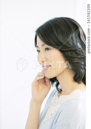 Portrait of a smiling middle-aged woman 141592209