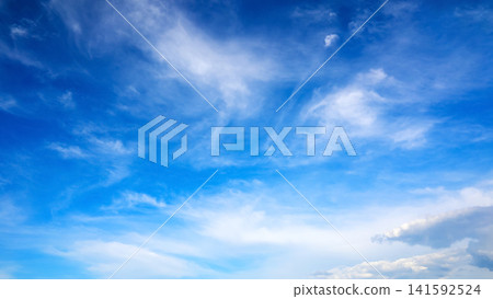 blue open sky with light wispy clouds on a bright sunny day blue open sky with light wispy clouds on a bright sunny day 141592524