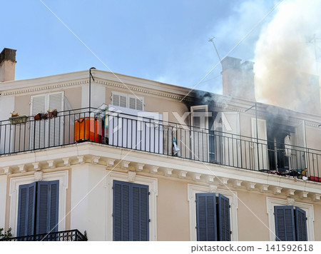 Residential fire with smoke above city apartment building Residential fire with smoke above city apartment building 141592618
