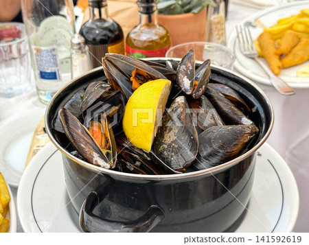 Fresh steamed mussels served with lemon in France 141592619