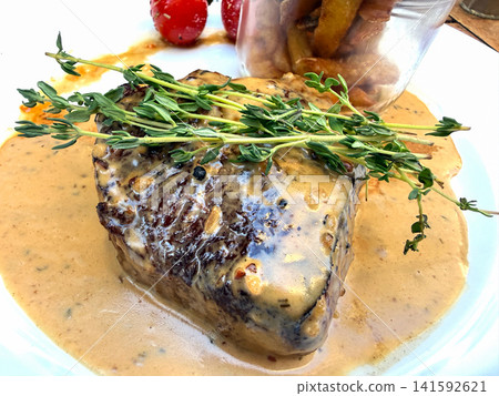 Grilled beef steak with creamy sauce and thyme 141592621
