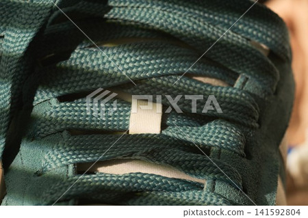 Sneaker style overview. Topdown view of sport shoe details. Closeup perspective highlighting shoe eyelets and lacing system Sneaker style overview. Topdown view of sport shoe details. Closeup perspective highlighting shoe eyelets and lacing system 141592804