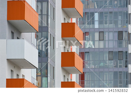 Multi-story building exterior with windows and air conditioners Multi-story building exterior with windows and air conditioners 141592832
