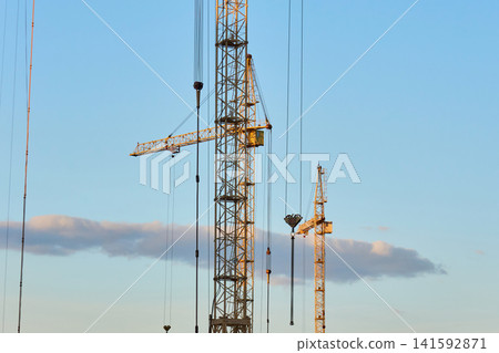 Modern residential apartment buildings under construction with cranes Modern residential apartment buildings under construction with cranes 141592871