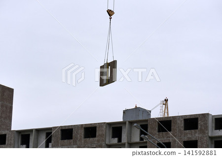 Construction process: hoisting a reinforced concrete panel in the air Construction process: hoisting a reinforced concrete panel in the air 141592881