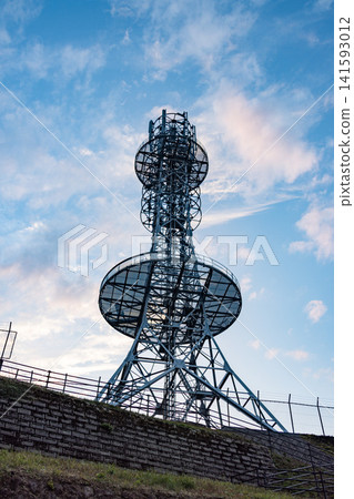 A radio tower soars into the twilight sky. A radio tower soars into the twilight sky. 141593012