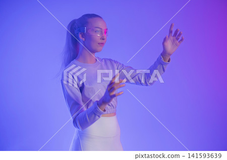 Woman in futuristic purple lighting Woman in futuristic purple lighting 141593639