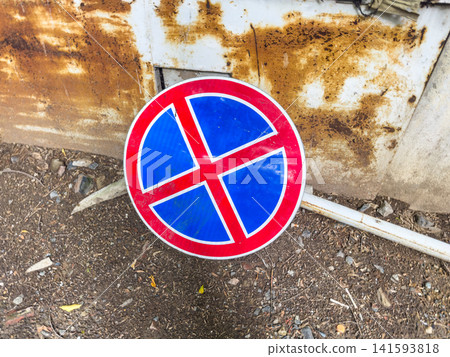 No parking sign with red border and blue background placed on rusty metal surface No parking sign with red border and blue background placed on rusty metal surface 141593818